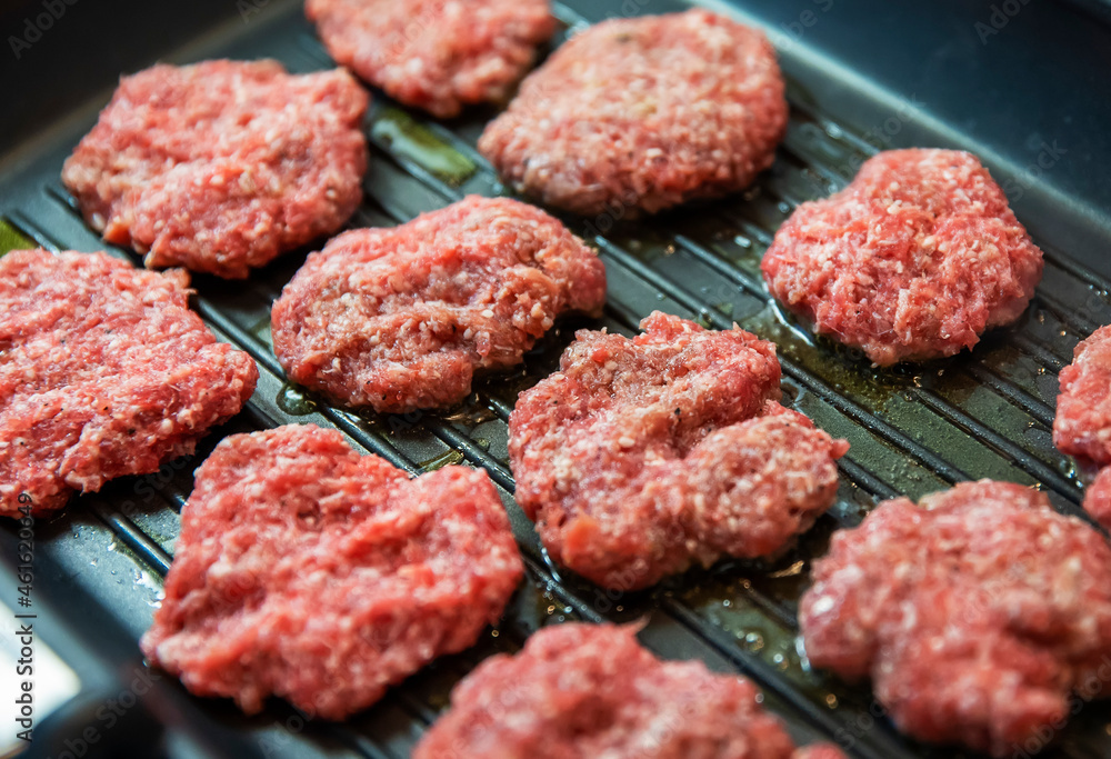 Frying four round beef meat for hamburger Frying four round beef meat for hamburger