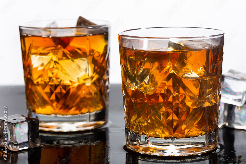 Whiskey in old fashioned glasses with ice, close up Whiskey in old fashioned glasses with ice, close up