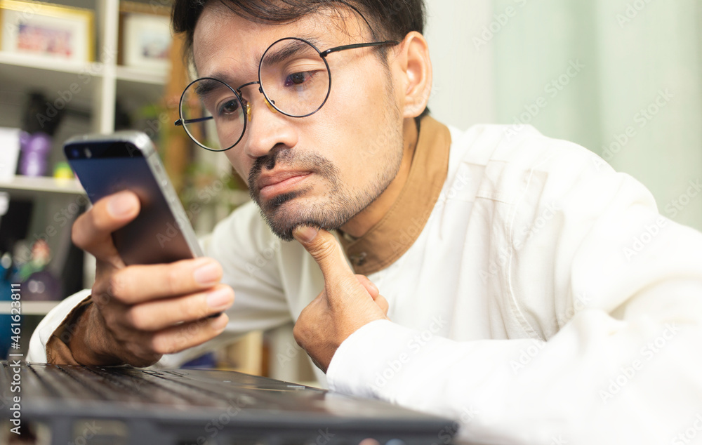 Young person or student using smartphone with online learning and study with look like worry something, online learning concept Young person or student using smartphone with online learning and study with look like worry something, online learning concept