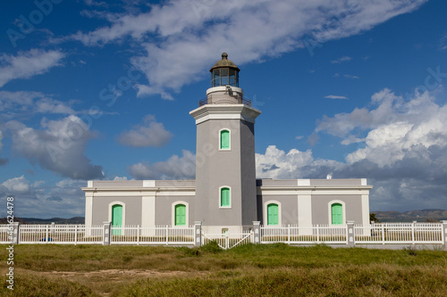 Cabo Rojo Lighthouse or Faro Los Morrillos de Cabo Rojo against the blue sky in Puerto Rico photo