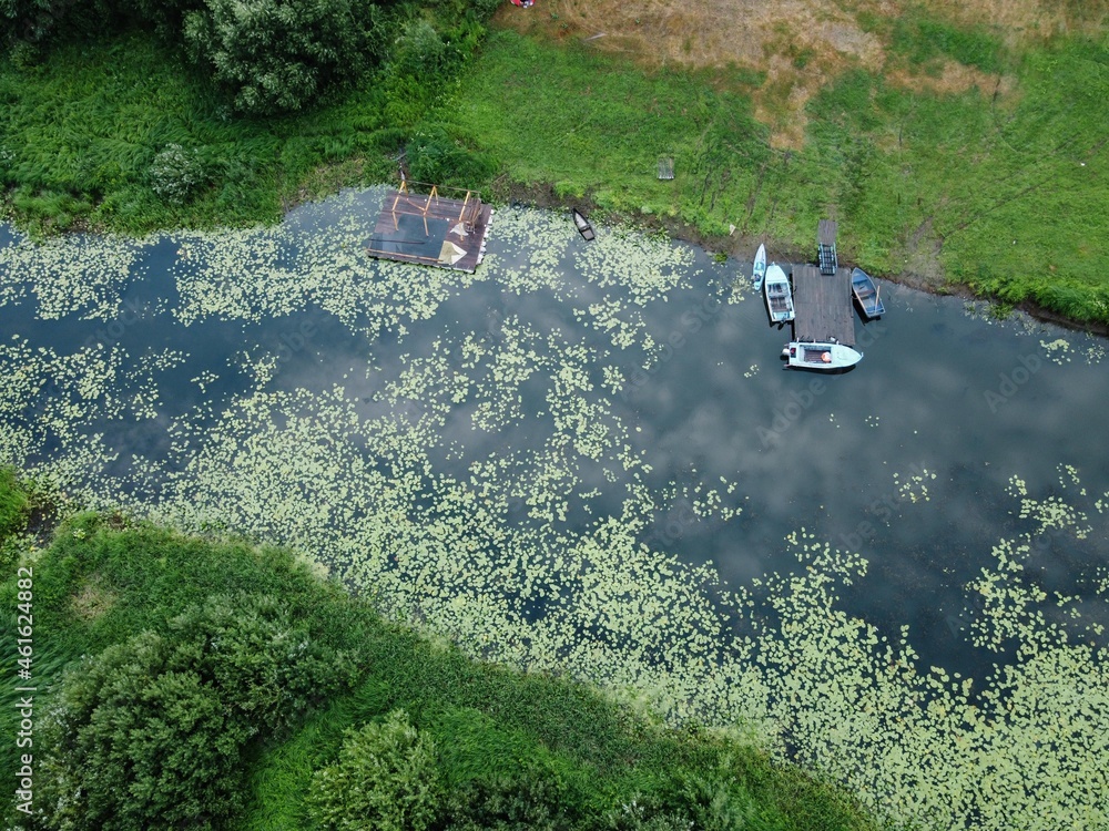 wild river and pier with boats, top view wild river and pier with boats, top view