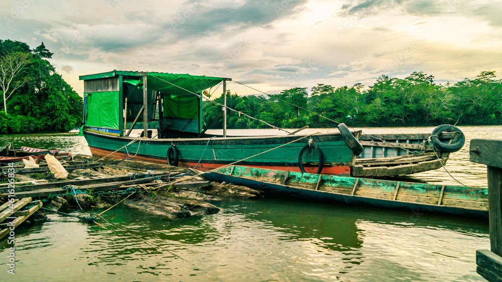 Traditional wooden boat as main transportation in upper Mahakam. Wooden boat docked in Mahakam river