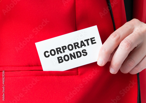 Motivational words: corporate bonds. Man holds a piece of card with the text: corporate bonds. Business and finance concept