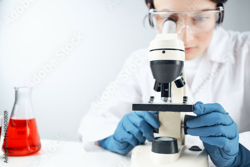 Woman in white coat laboratory science microscope