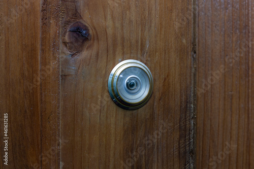 peephole on a wooden door, close-up