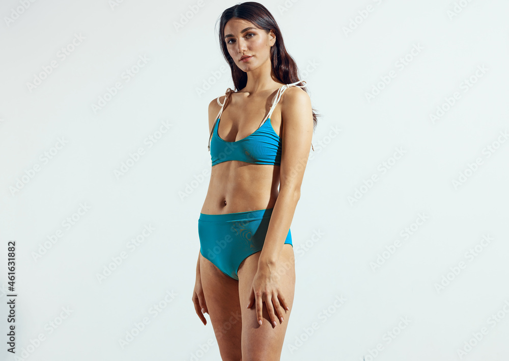 Obraz premium pretty woman in blue bikini swimwear posing beach