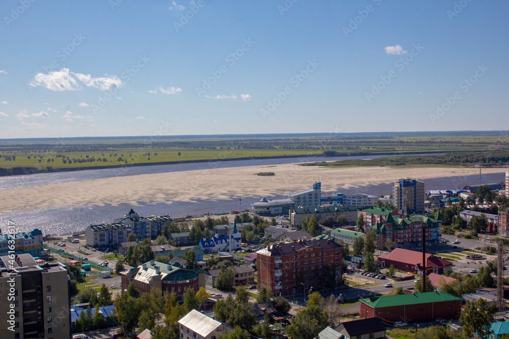 Obraz premium View from the hill to the capital of the Khanty-Mansiysk Autonomous Okrug - Ugra Khanty-Mansiysk. View of the city, the Irtysh river and the river port.