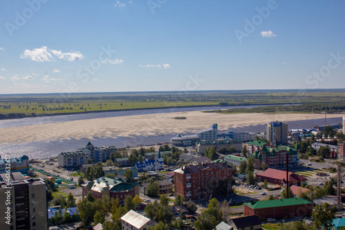 View from the hill to the capital of the Khanty-Mansiysk Autonomous Okrug - Ugra Khanty-Mansiysk. View of the city, the Irtysh river and the river port.
