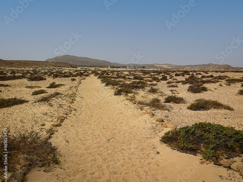 Arid desert weather and volcanic rocks in the distance  Espingueira  Cape Verde. Blue sky over an African Island. Selective focus on the horizon  blurred background.