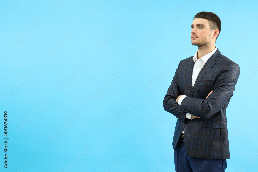 Young businessman on blue background, space for text Young businessman on blue background, space for text