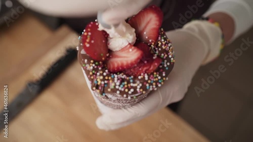 Cinematic shallow focus shot of yummy looking chimney cake topped with whipped cream photo