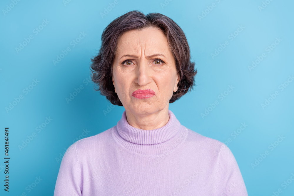 Photo of elderly woman unhappy sad upset negative dislike disgusted bad aroma isolated over blue color background Photo of elderly woman unhappy sad upset negative dislike disgusted bad aroma isolated over blue color background