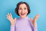 Photo of mature excited woman happy positive smile amazed surprised news sale isolated over blue color background