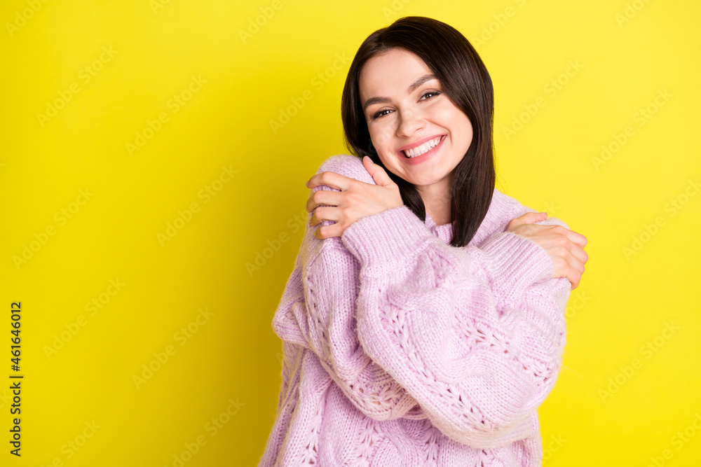 Photo of sunny cheerful brown hairdo lady hug herself wear pink sweater isolated on vivid yellow color background Photo of sunny cheerful brown hairdo lady hug herself wear pink sweater isolated on vivid yellow color background