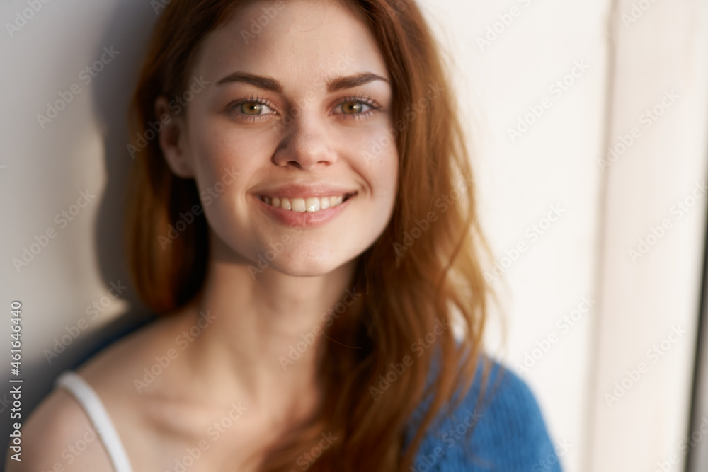 beautiful woman sitting on the windowsill with a blue plaid beautiful woman sitting on the windowsill with a blue plaid