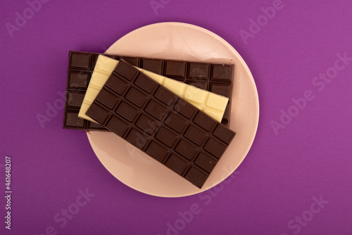 Chocolate with plate on purple table
