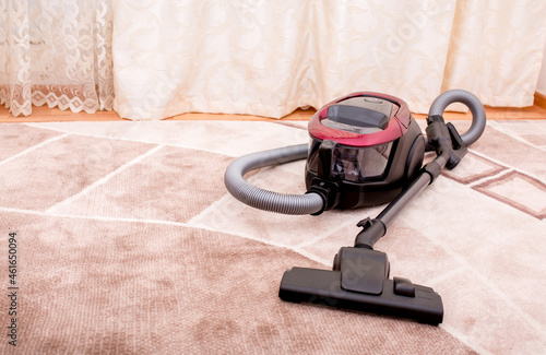 Vacuum cleaner in the room on the carpet, cleanliness in the house, cleaning
