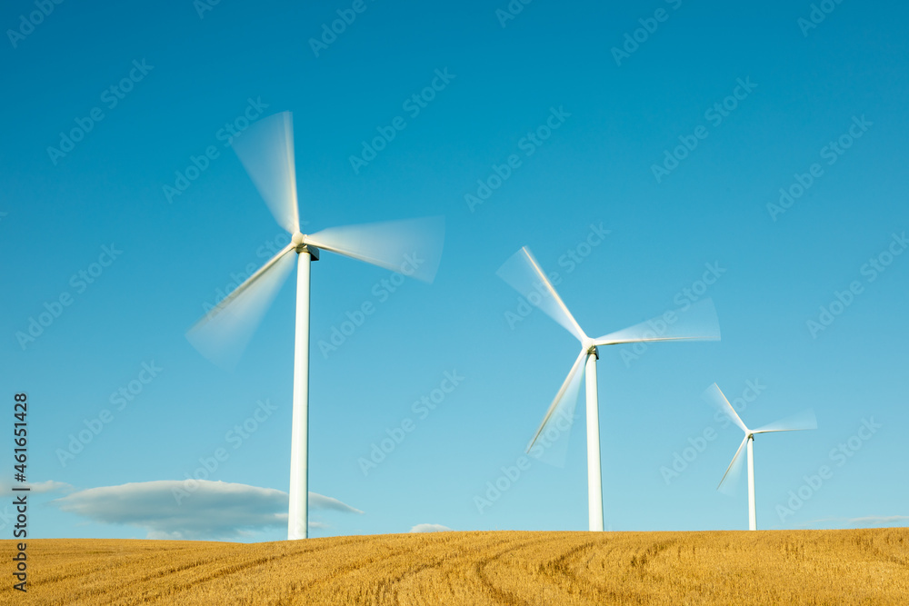 Wind farm, modern windmills on a bright and sunny day Wind farm, modern windmills on a bright and sunny day