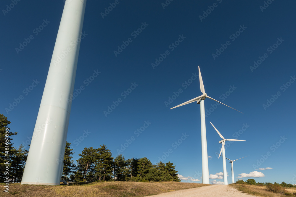 Wind farm, modern windmills on a bright and sunny day Wind farm, modern windmills on a bright and sunny day