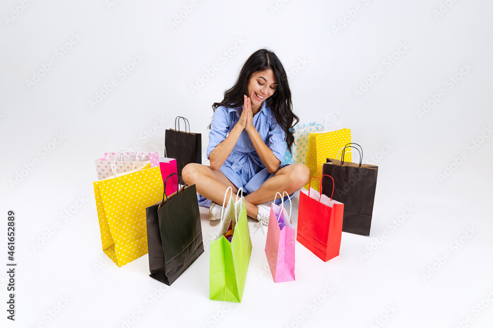 Close-up tired emotive young girl after shopping at black friday sales. Model with lots of bags, colorful bright packages Close-up tired emotive young girl after shopping at black friday sales. Model with lots of bags, colorful bright packages