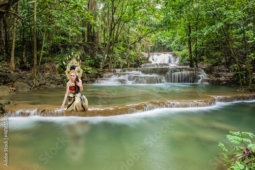 Fototapeta Naklejka Na Ścianę i Meble -  Beautiful woman in Thai dress in a waterfall