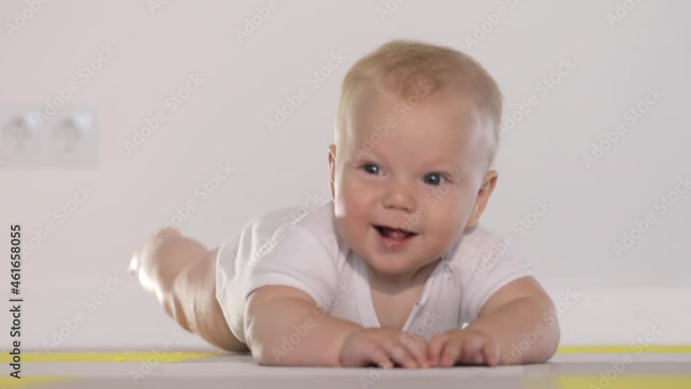 Cute smiling Baby rolls over on tummy Cute smiling Baby rolls over on tummy