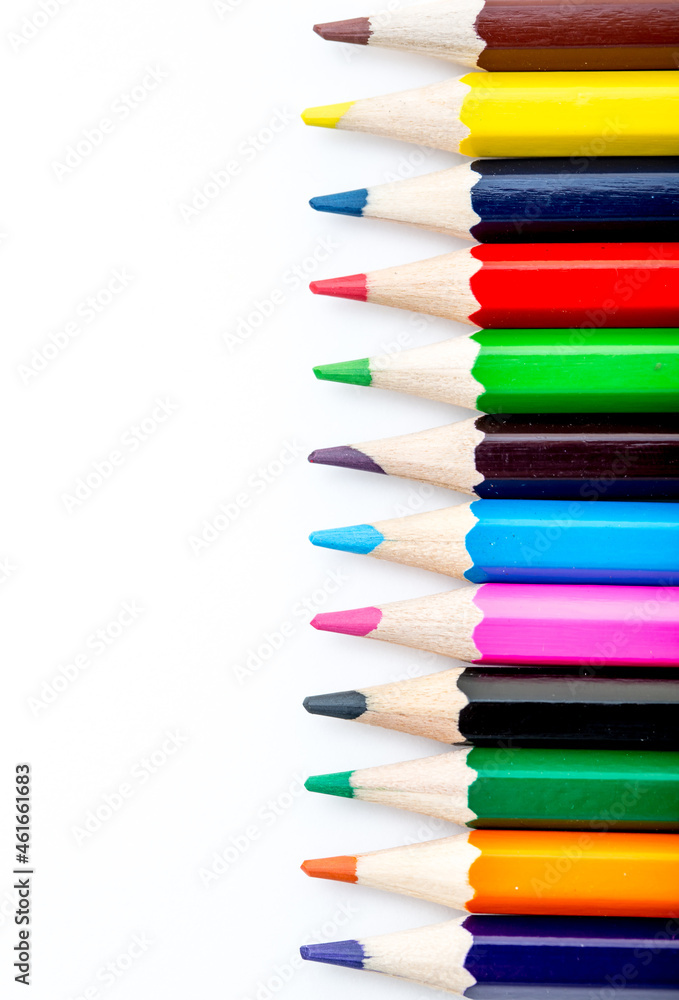 School stationery items. Creation Multicolored pencils on a blank white sheet. On a white background. Children's drawing, artist. School stationery items. Creation Multicolored pencils on a blank white sheet. On a white background. Children's drawing, artist.