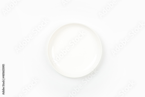White plate placed on a white background, top view