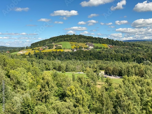 Bieszczady mountains in the vicinity of Lake Solinskie covered with forests and meadows sky blue clouds photo