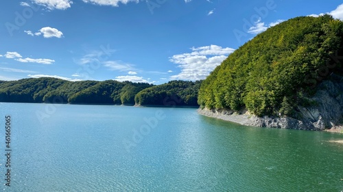 Lake Solinskie with rocky shores covered with dense coniferous forest photo