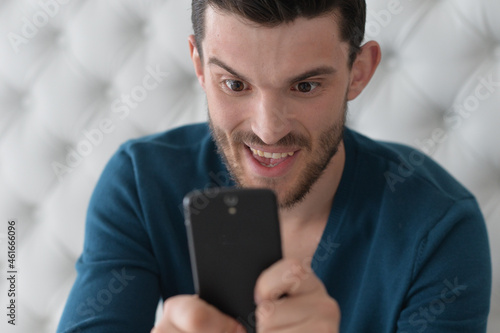 handsome young man holding smartphone