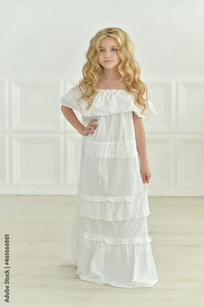 Beautiful girl in white dress posing in studio Beautiful girl in white dress posing in studio