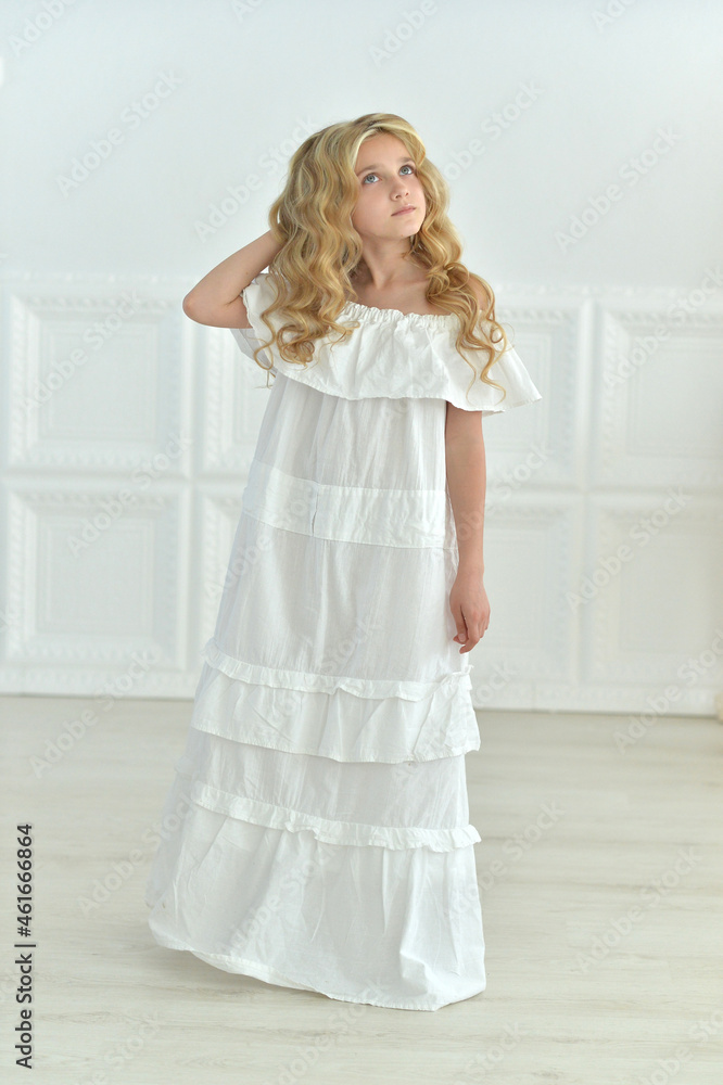 Beautiful girl in white dress posing in studio Beautiful girl in white dress posing in studio