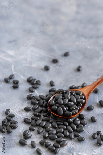 Wooden spoon full of black chickpea closeup