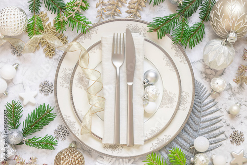 Festive table setting with fir tree branches and Christmas decorations