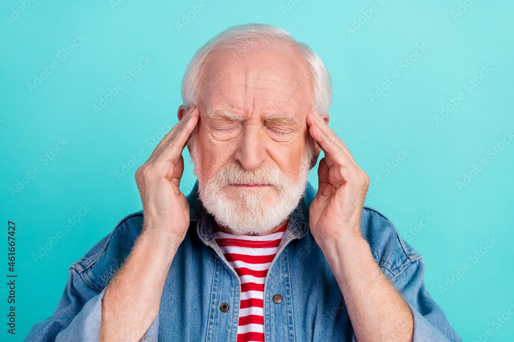 Portrait of attractive depressed grey-haired man touching temples feeling bad isolated over bright teal turquoise color background Portrait of attractive depressed grey-haired man touching temples feeling bad isolated over bright teal turquoise color background