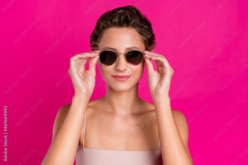 Photo of positive cool cheerful young lady wear sunglass charming face isolated on magenta color background