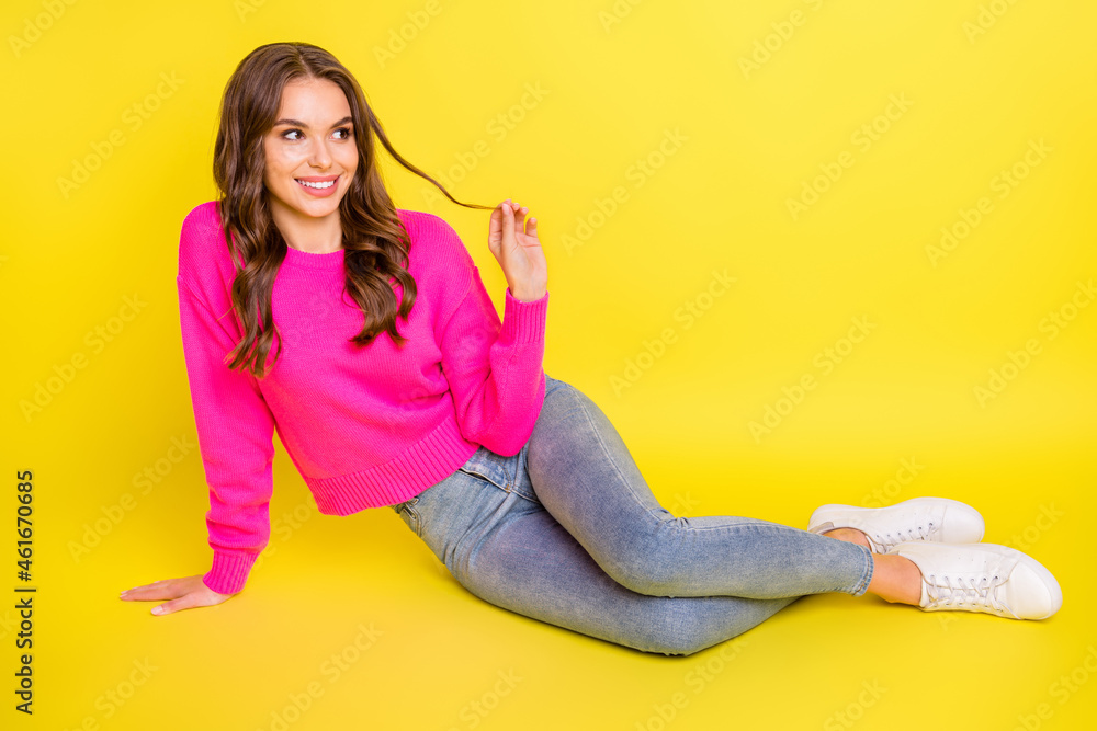 Photo of dreamy cute wavy young woman wear pink sweater sitting floor arm curl looking empty space isolated yellow color background Photo of dreamy cute wavy young woman wear pink sweater sitting floor arm curl looking empty space isolated yellow color background