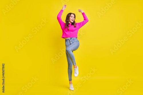 Full body photo of young attractive girl happy positive smile have fun dance isolated over yellow color background