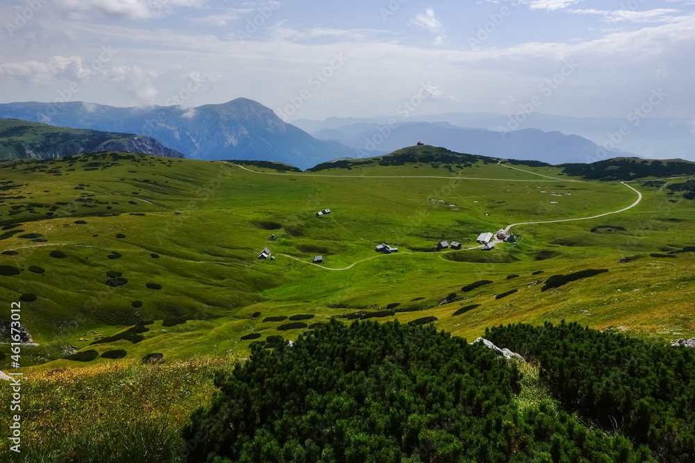 amazing green nature landscape with alpine huts and paths