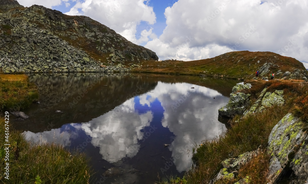 amazing reflections from the sky in a clear mountain lake panorama