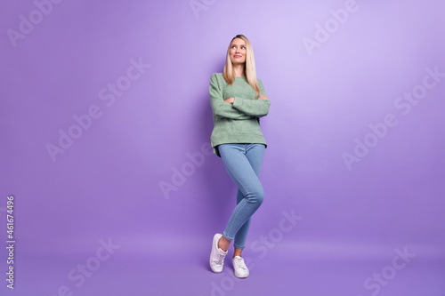 Full length photo of mature pretty woman wondered look empty space crossed hands isolated over violet color background