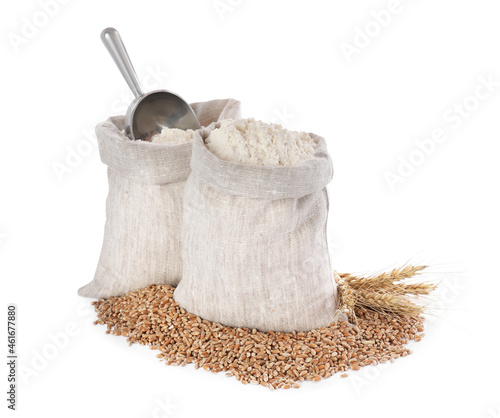 Sack with flour, wheat grains and spikes on white background