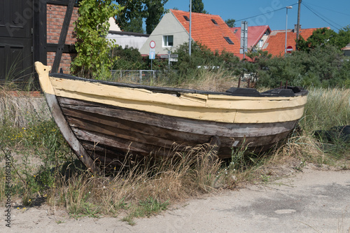 Old wooden fishing boat in the grass.