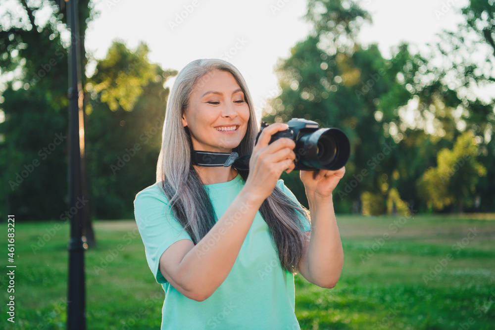 Portrait of attractive cheerful grey-haired woman making photos capture snap natural landscape outdoors Portrait of attractive cheerful grey-haired woman making photos capture snap natural landscape outdoors