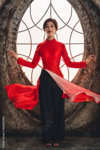 Vietnamese woman dressed in a traditional red ao dai dress photo