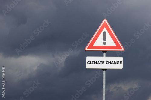 A sign with a exclamation mark warning for a dangerous situation ahead and a smaller sign below with the English text Climate Change on it