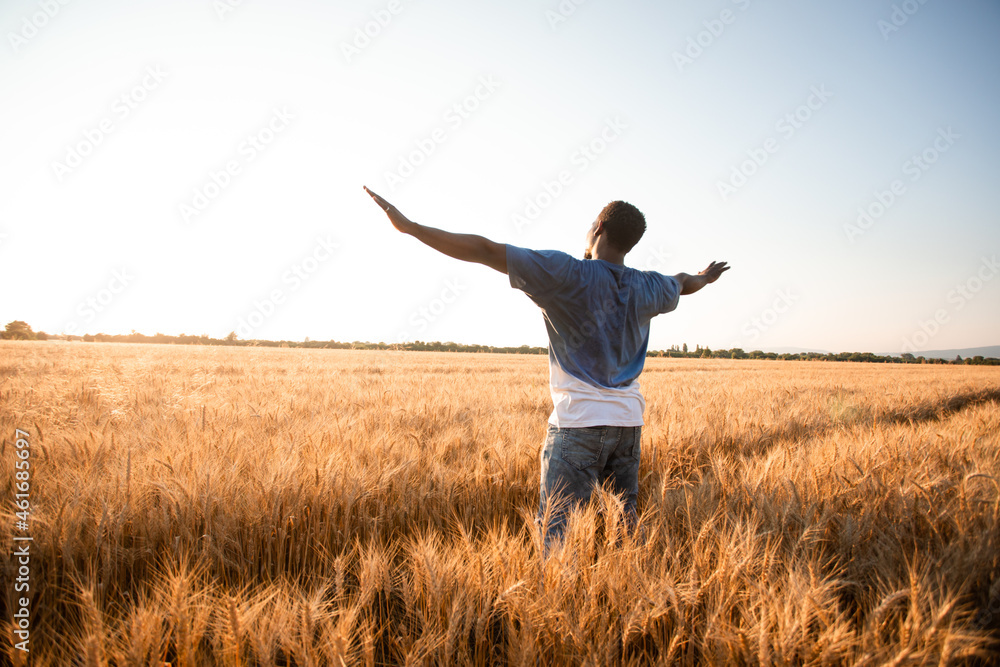 Unspecified man with hands up watching sunset Unspecified man with hands up watching sunset