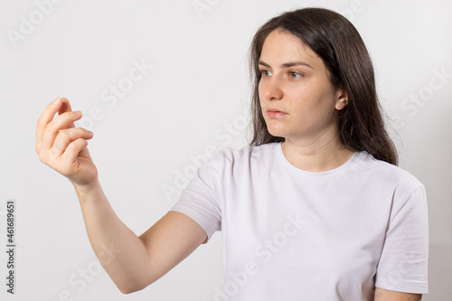 Wallpaper Mural A brunette woman looks at her hand with space for text in white. Torontodigital.ca
