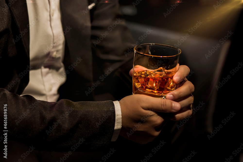 Closeup businessmen holding a glass of whiskey